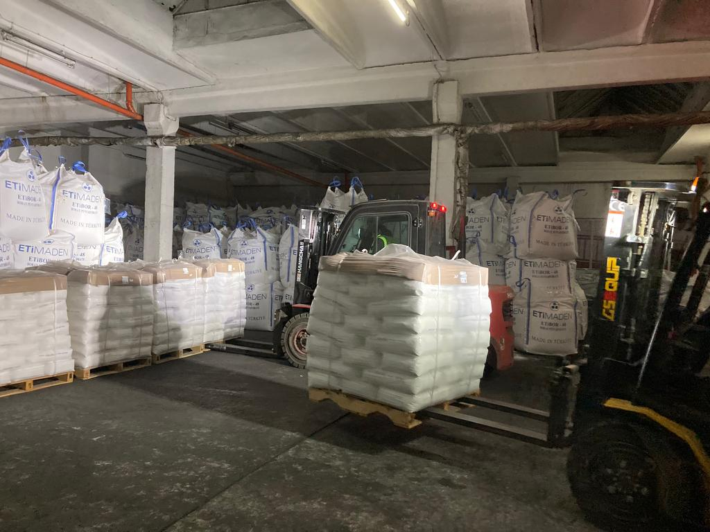 Palletised and bagged cargoes handled by forklifts in a warehouse