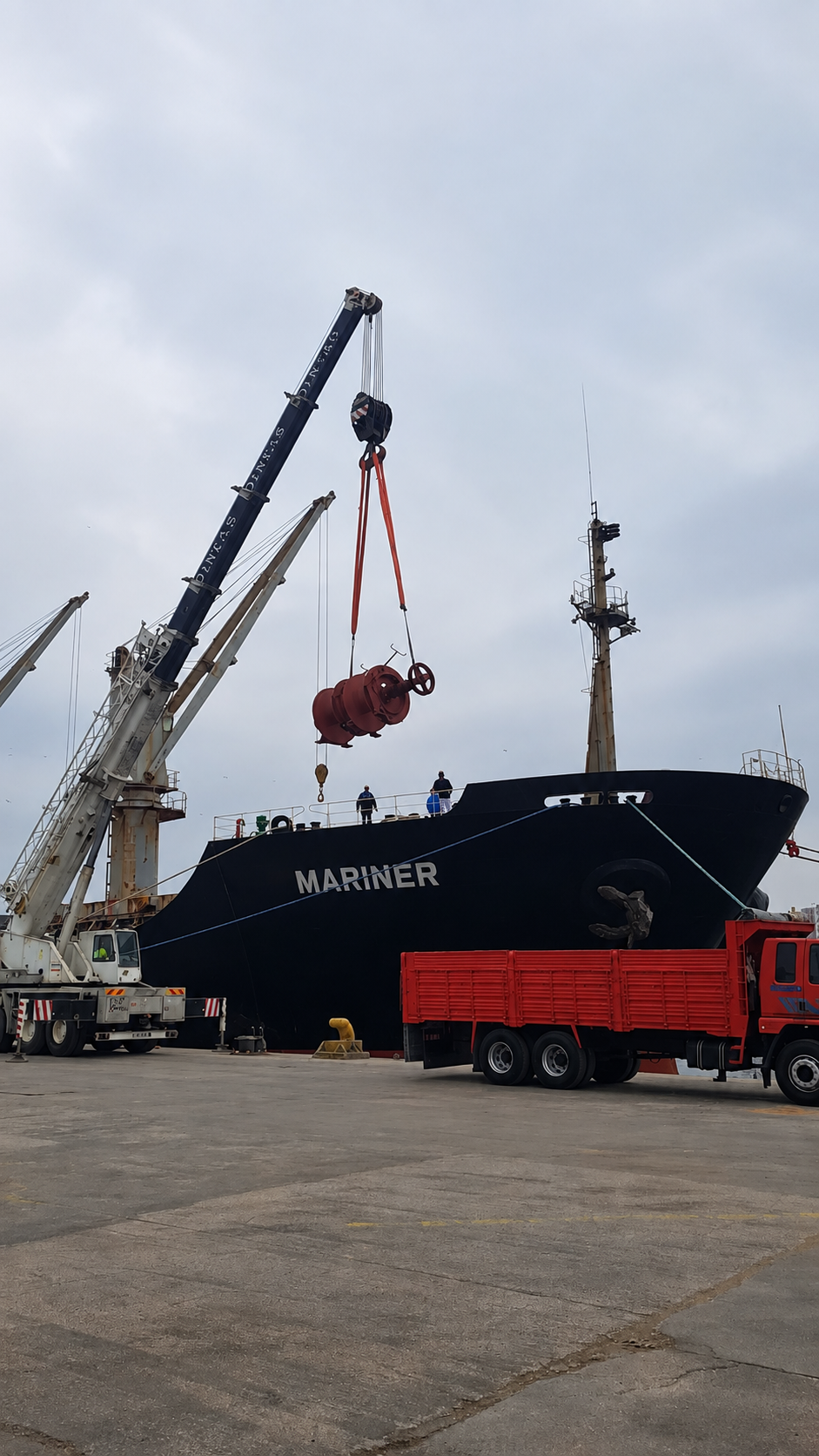 Spare part being delivered to a vessel by crane in port